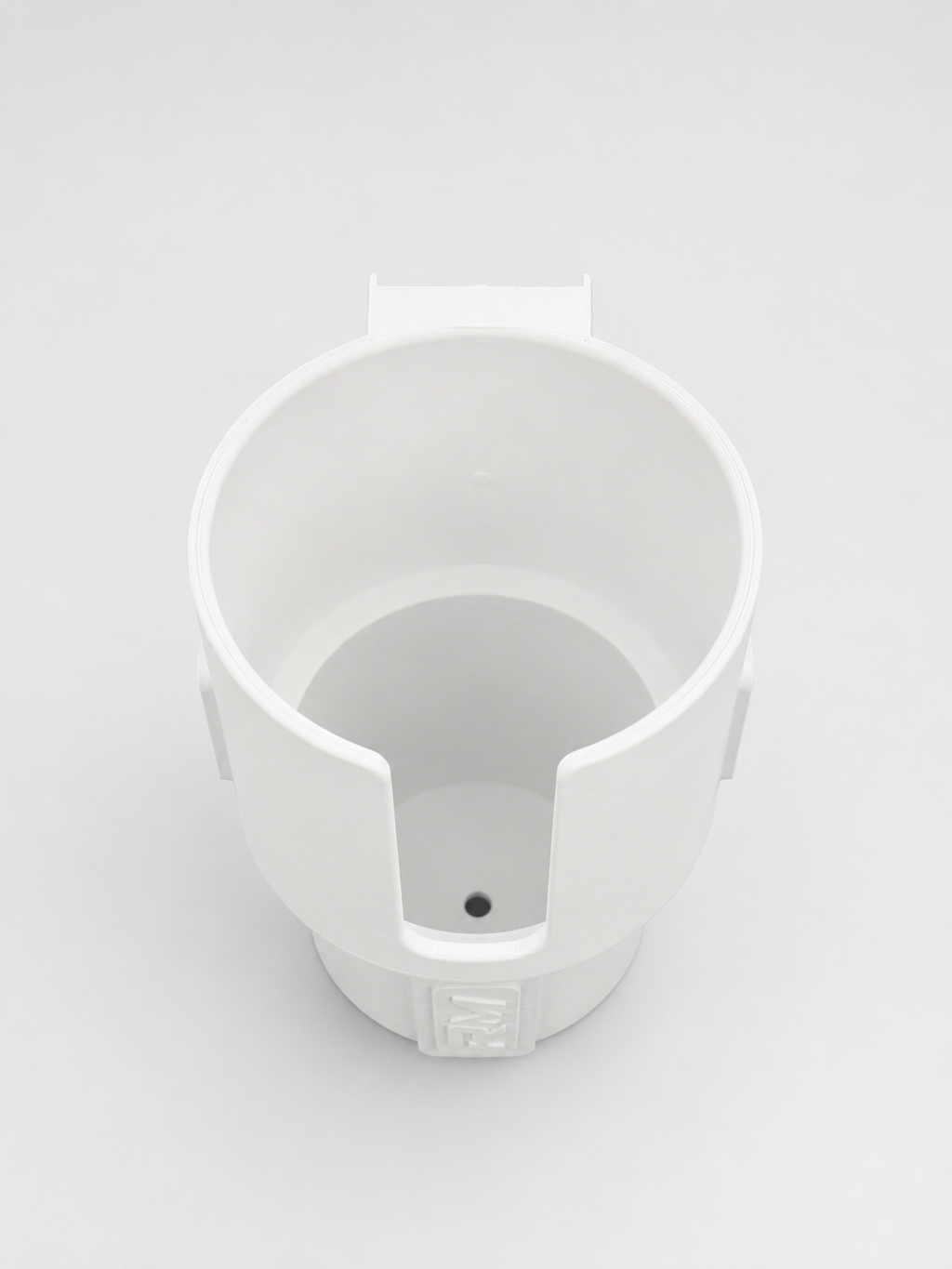 Top view of white RepRail universal boat cup holder showing open-front design and integrated drain